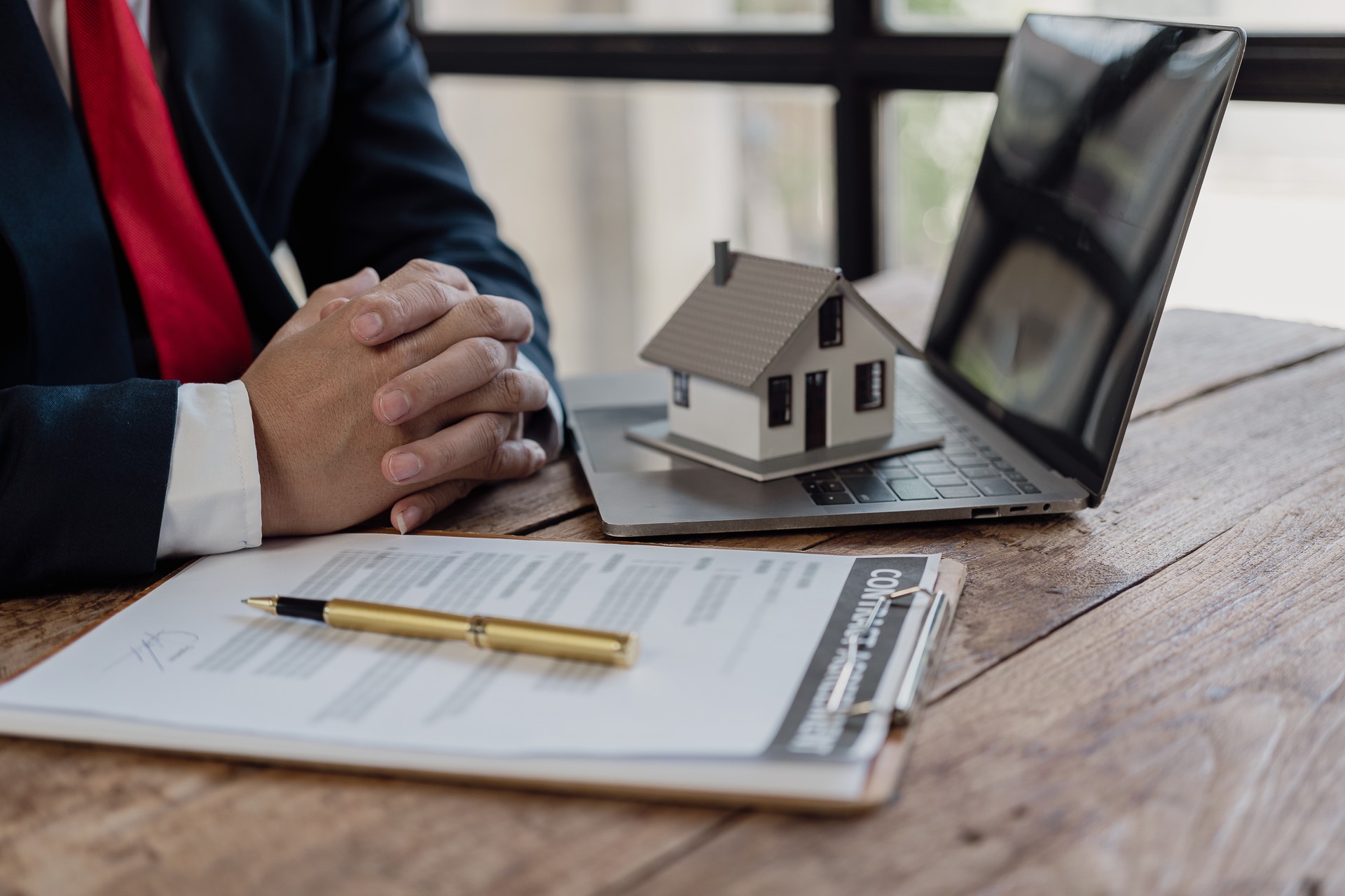 Businessman working on financial investments in the office Protection insurance provides home for protection and care, real estate sales concept, close-up