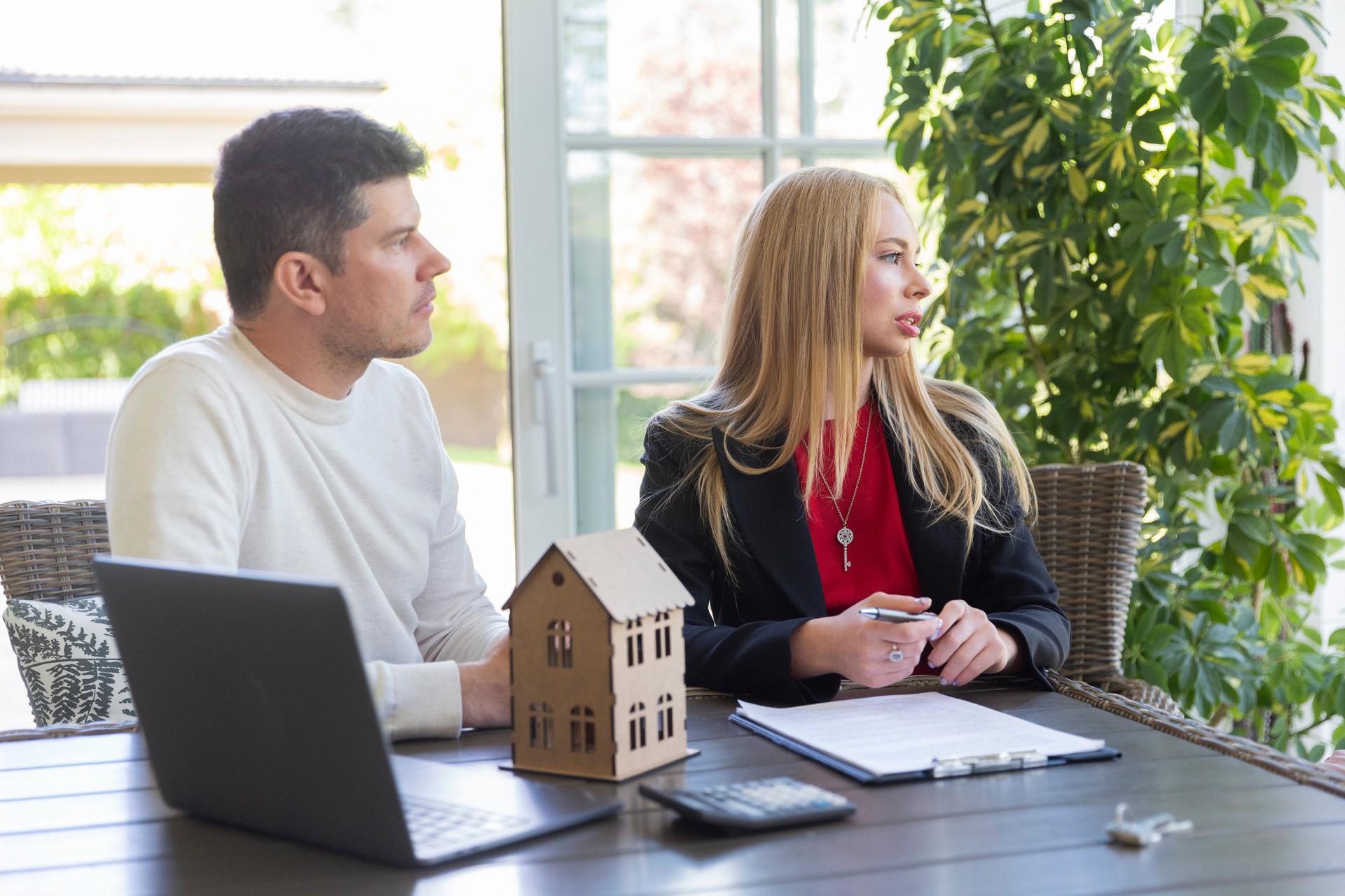 Female estate agent shows available variant to businessman